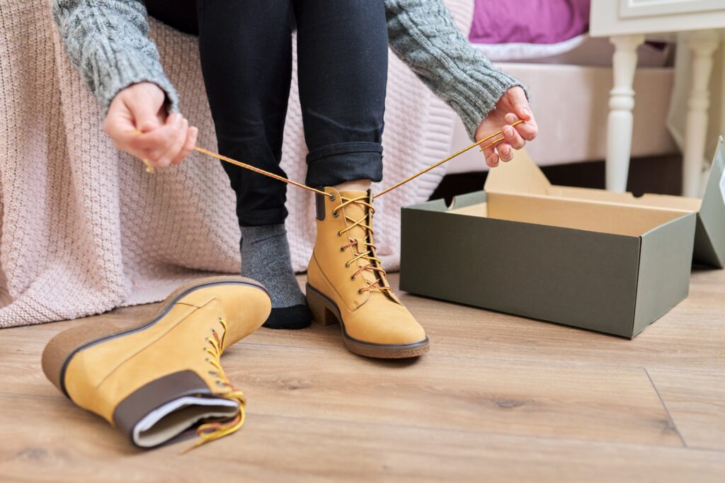 Autumn winter season, new shoes, close-up woman shoeing warm boots